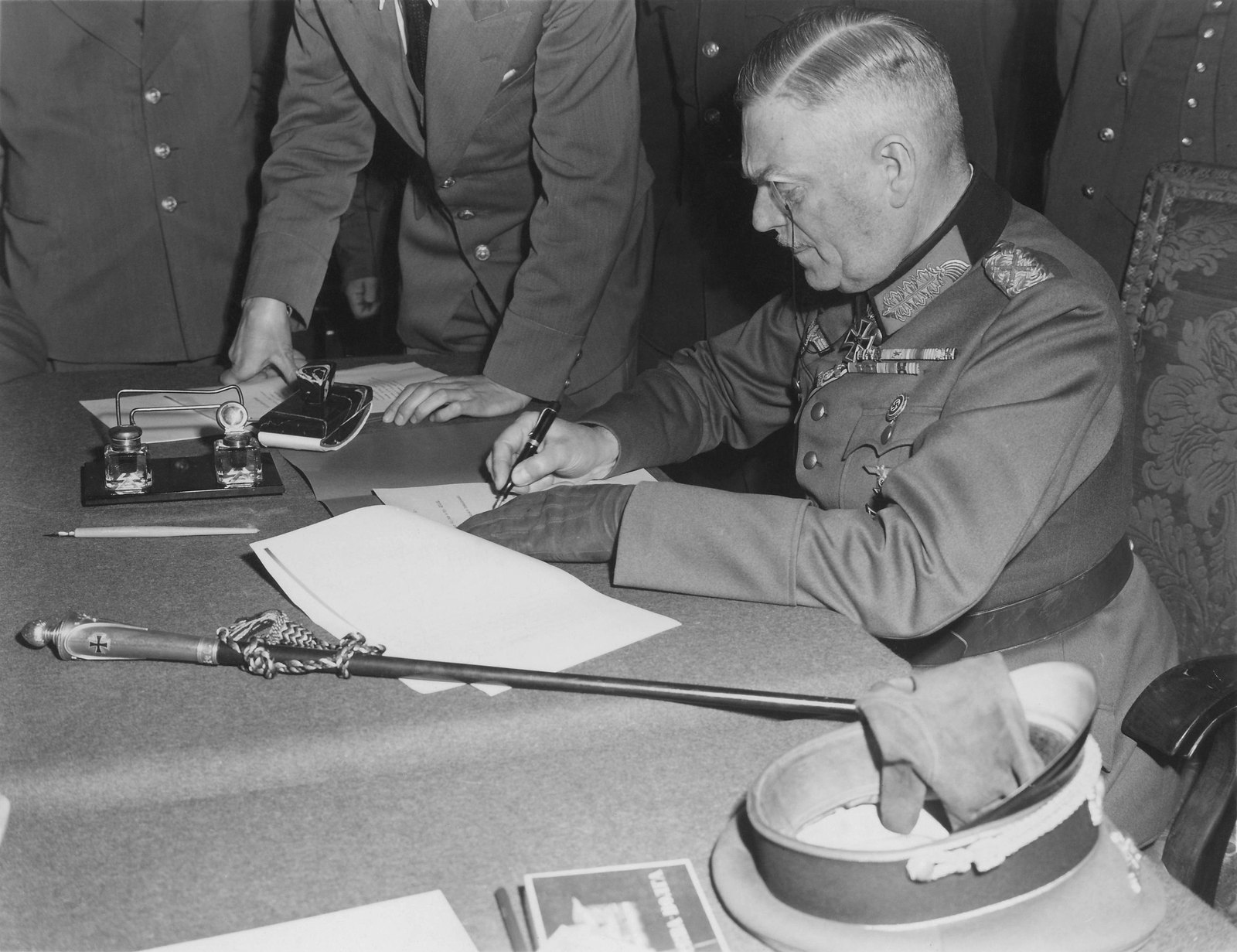Field Marshal Wilhelm Keitel signs the unconditional surrender of the German armed forces at Soviet headquarters in Berlin Karlshorst on 8 May 1945, his marshal's baton on the table
