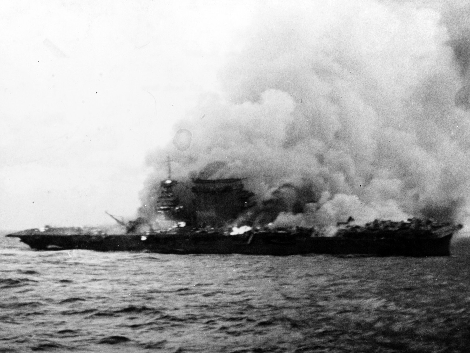 USS Lexington burning and sinking after her crew abandoned ship in the Battle of the Coral Sea, 8 May 1942