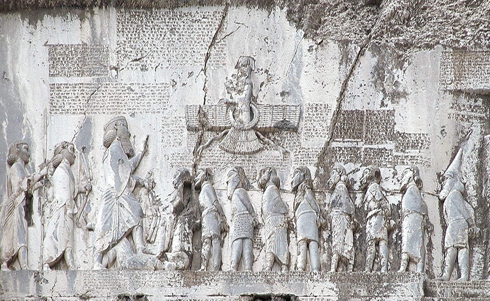 The Behistun relief: Darius the Great, under the winged symbol of Ahura Mazda, faces a line of bound rebel kings