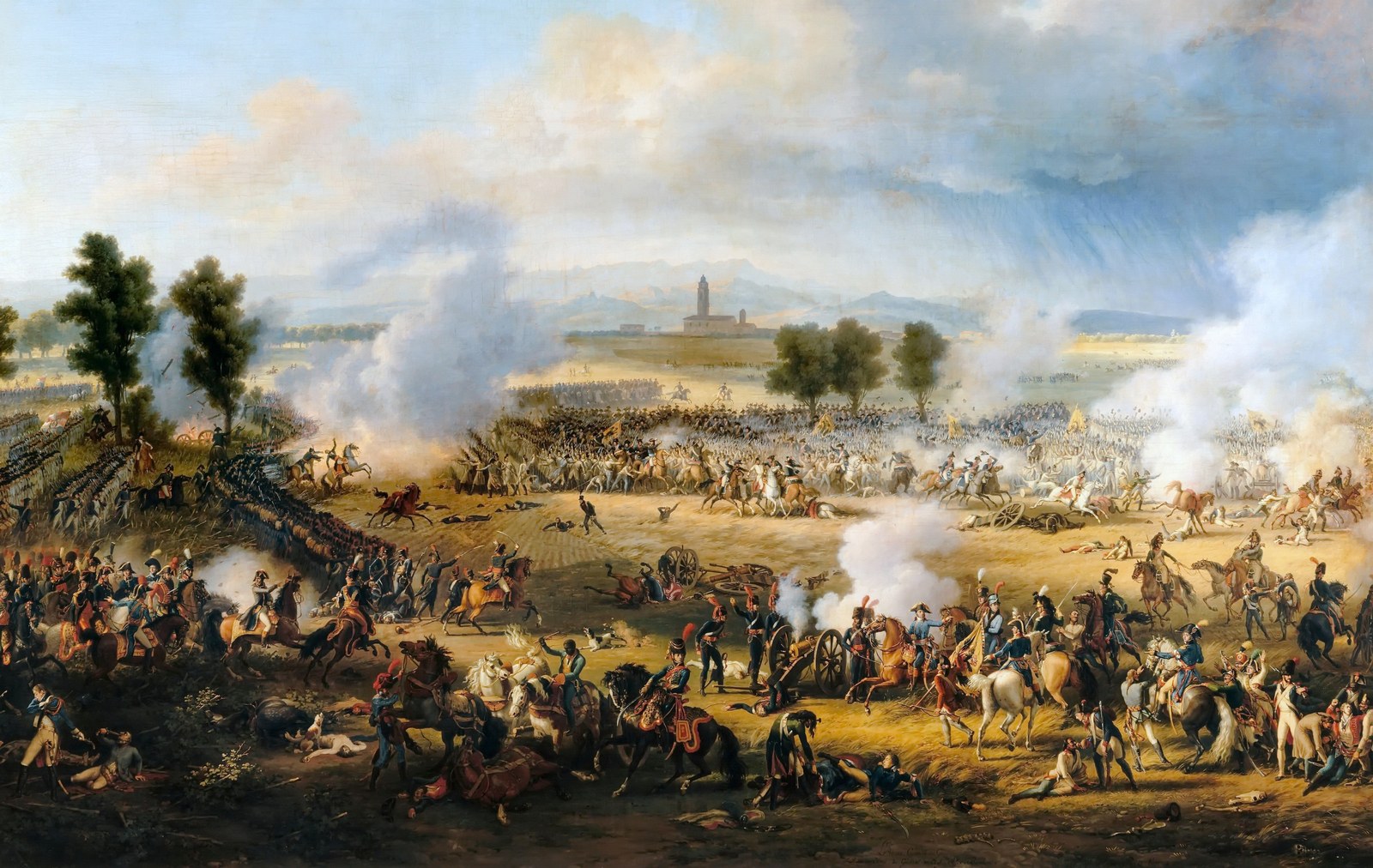 Wide panoramic oil painting of a battle on a flat plain: in the foreground French generals on horseback beside a firing cannon and wounded soldiers, in the middle distance cavalry charging through clouds of gun smoke, and on the horizon a village bell tower under a stormy sky.