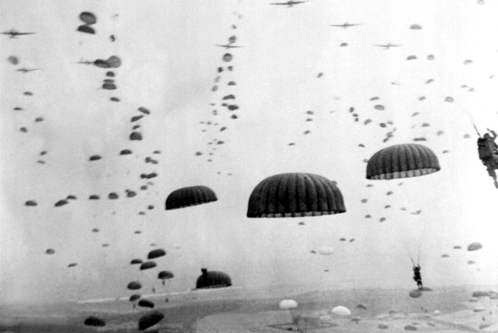 Parachutes open overhead as waves of Allied paratroopers land in Holland, September 1944