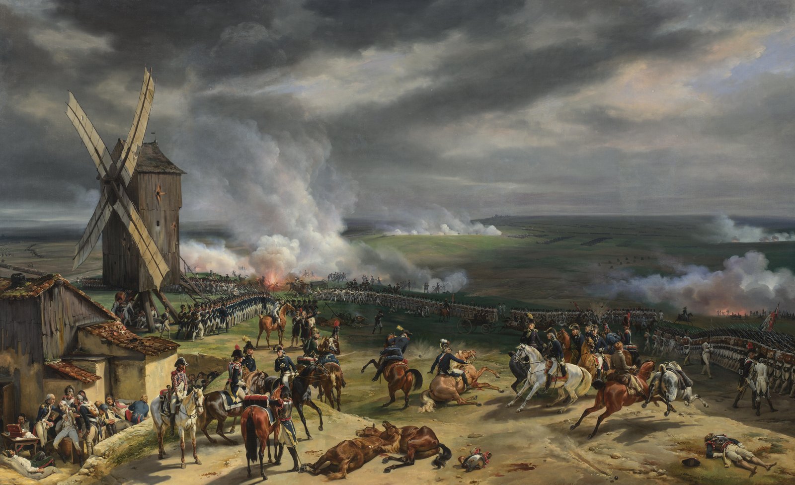 Oil painting of a battlefield under a cloudy sky: a windmill on a rise, mounted officers and lines of infantry in blue coats, and cannon smoke across a wide plain.