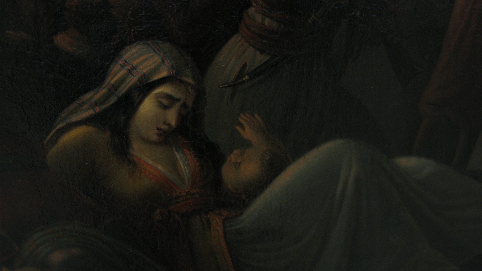 Detail of a nineteenth-century oil painting in dark tones: a young woman in a striped headscarf holds a sleeping child wrapped in white, with armed men looming in the shadows behind her.