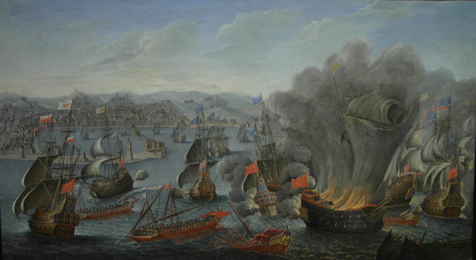 Seventeenth-century painting of the Battle of Palermo: sailing warships and oared galleys with red and blue flags crowd the bay in front of the walled city and its mole, while on the right a burning ship explodes in a column of flame and gray smoke.
