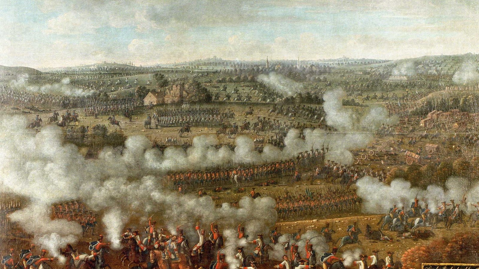 Eighteenth-century painting of a wide battlefield under a cloudy sky: lines of infantry wreathed in gunsmoke cross the plain while cavalry clash in the foreground among fallen horses.