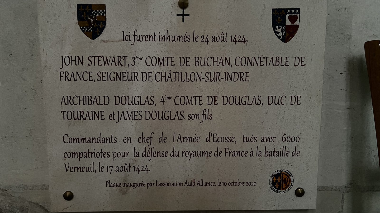Stone memorial plaque in Tours cathedral with two coats of arms, naming John Stewart, Earl of Buchan, and Archibald Douglas, Earl of Douglas, killed at Verneuil on 17 August 1424.