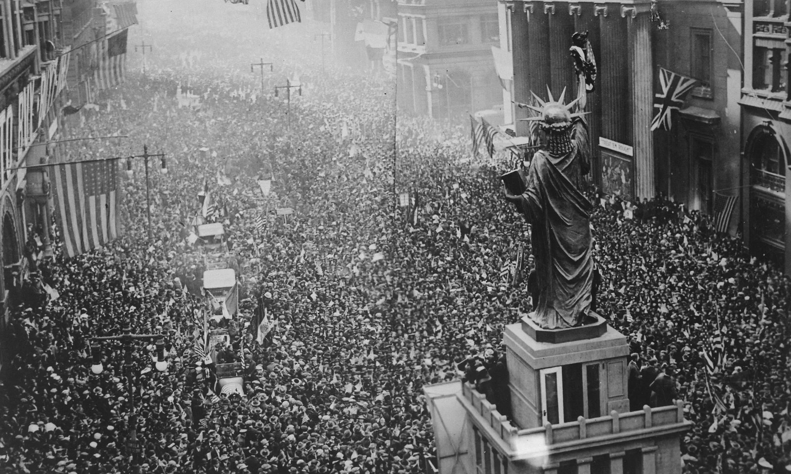 Huge crowds with American and British flags fill a Philadelphia street to celebrate the Armistice on 11 November 1918
