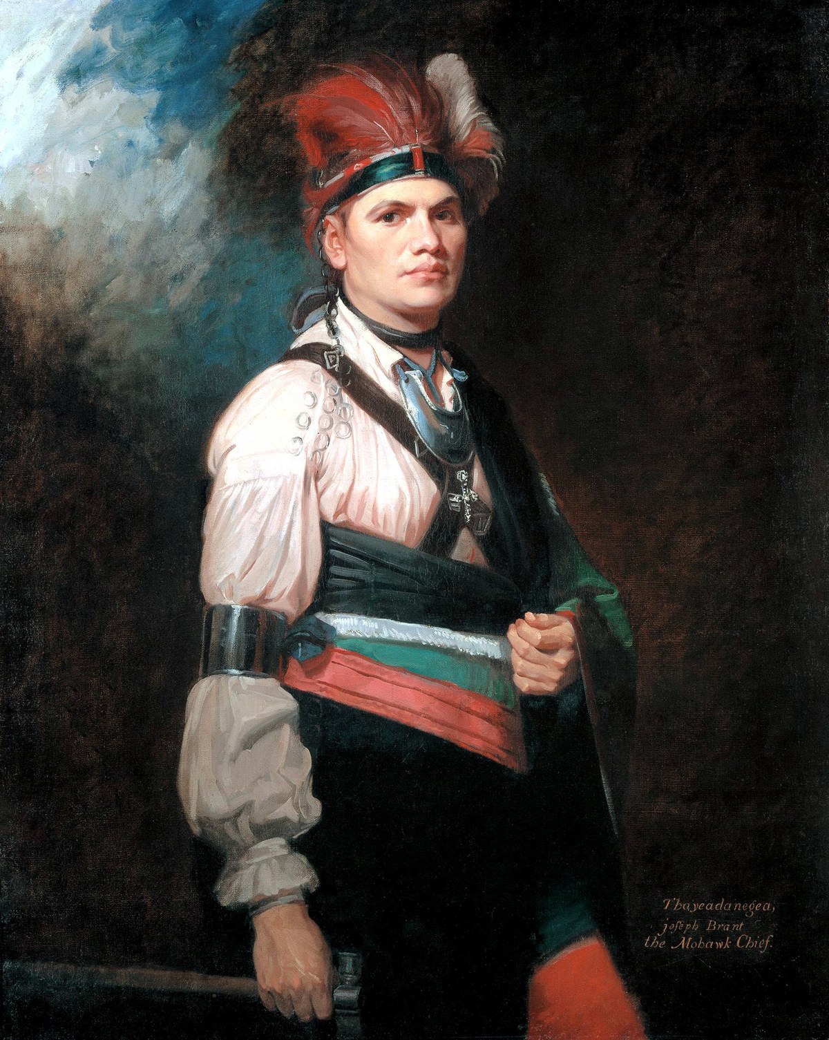 Oil portrait of a young Mohawk man in a white ruffled shirt, a dark blanket over one shoulder, a silver gorget at his throat and a plumed headdress.