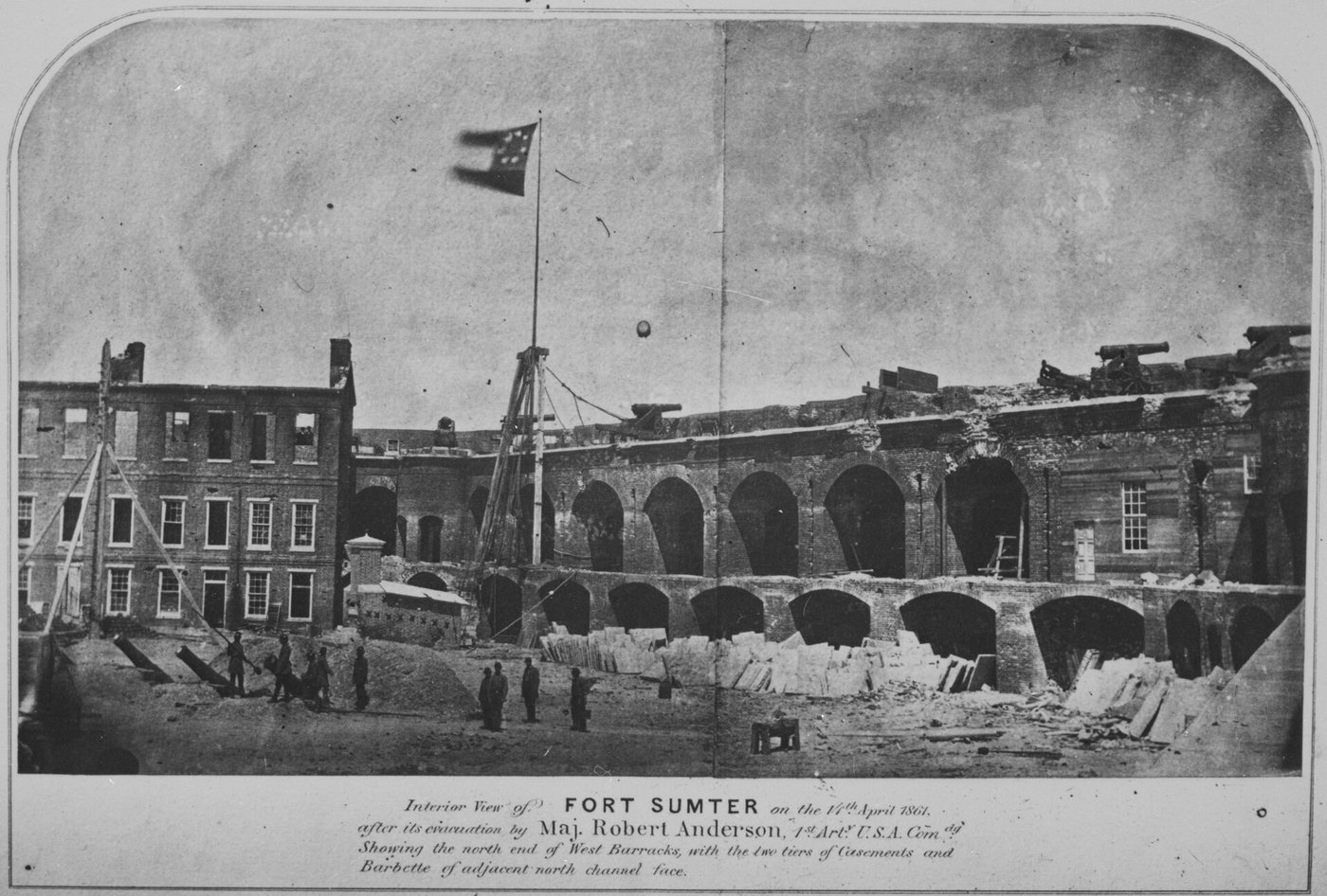 Photograph of the damaged interior of Fort Sumter with a Confederate flag on a tall staff