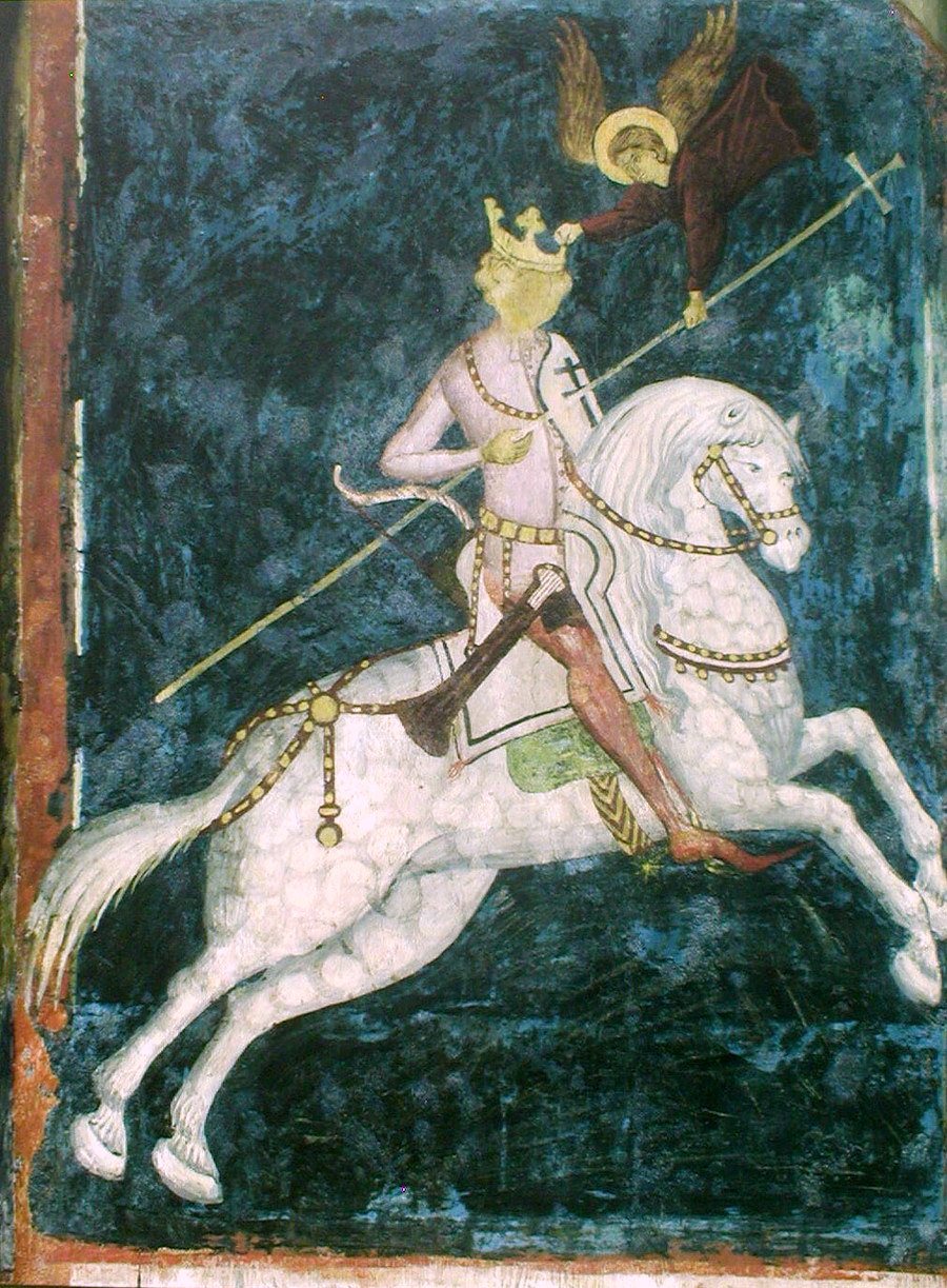 Medieval fresco of a crowned king riding a white horse, an angel above him