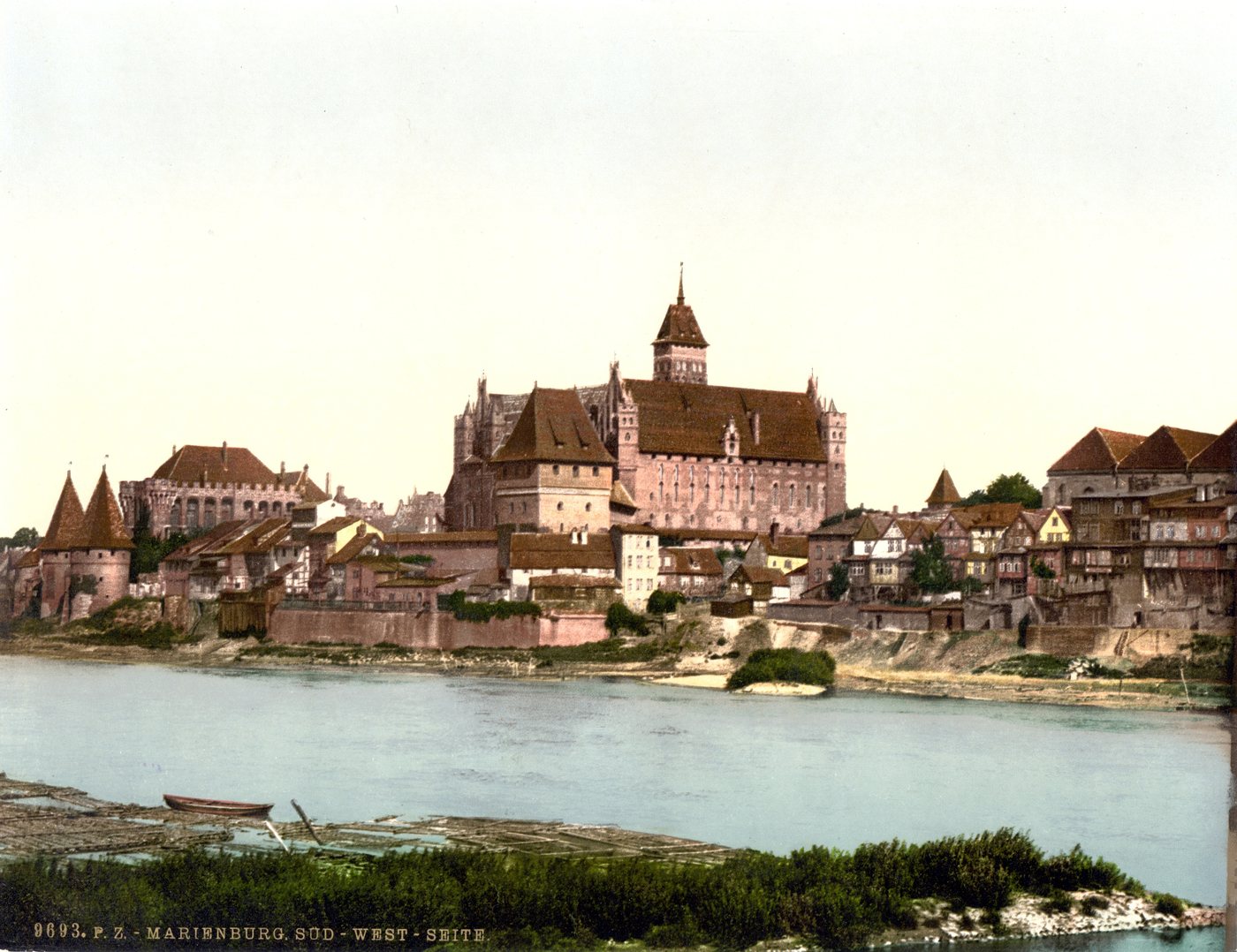 Colour photochrom of a great red brick castle above a river