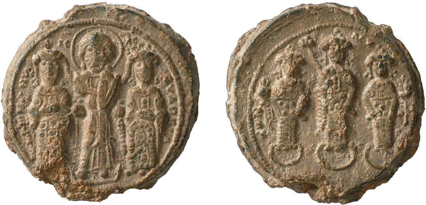 Both faces of a worn lead seal showing standing imperial figures beside Christ
