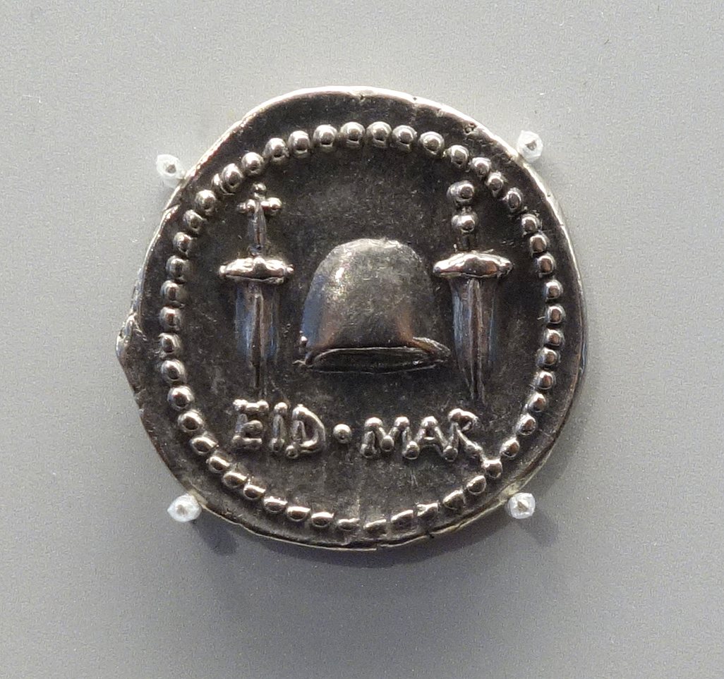 Silver Roman coin showing a cap between two daggers and the inscription EID MAR