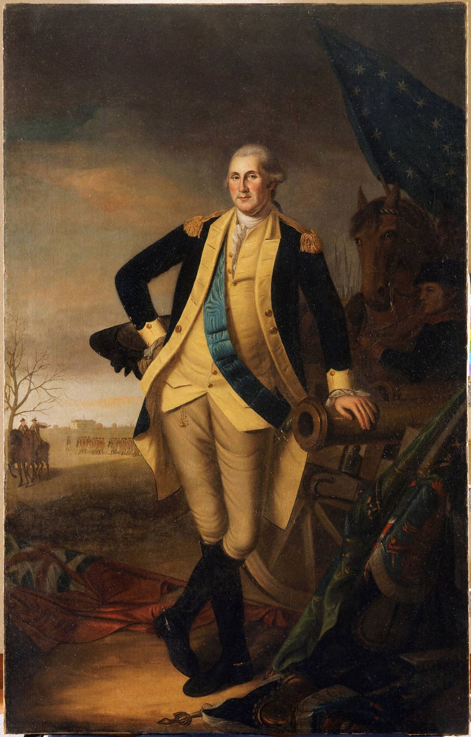Full length portrait of Washington in a blue and buff uniform leaning on a cannon, a flag behind him