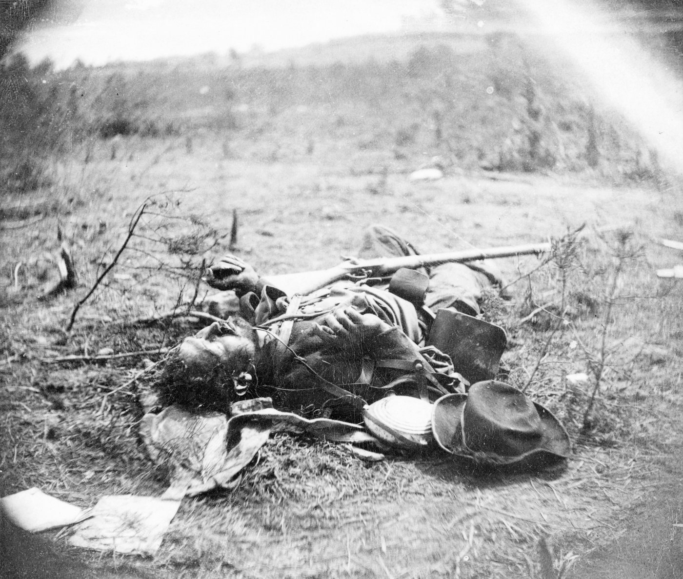 Photograph of a dead soldier lying on the ground