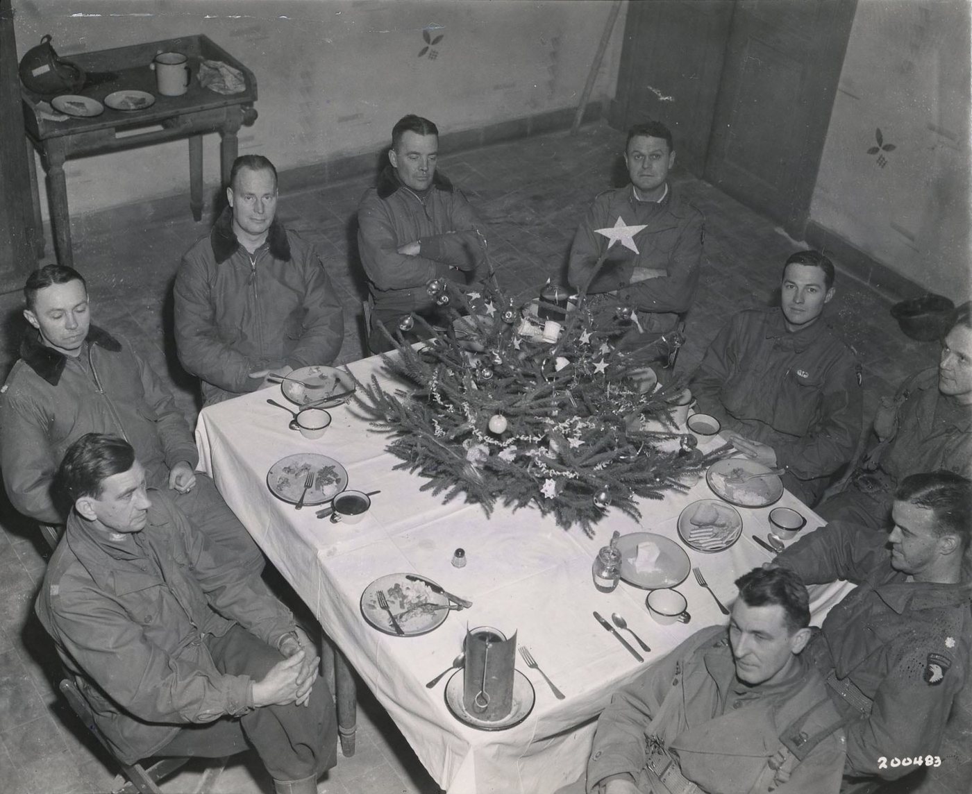 American officers seated around a table with a small Christmas decoration