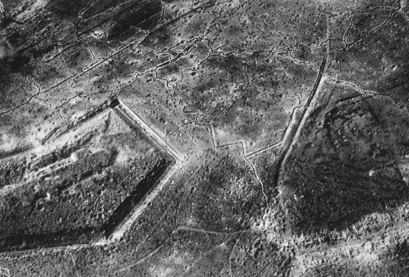 Aerial photo of a polygonal fort surrounded by countless shell craters