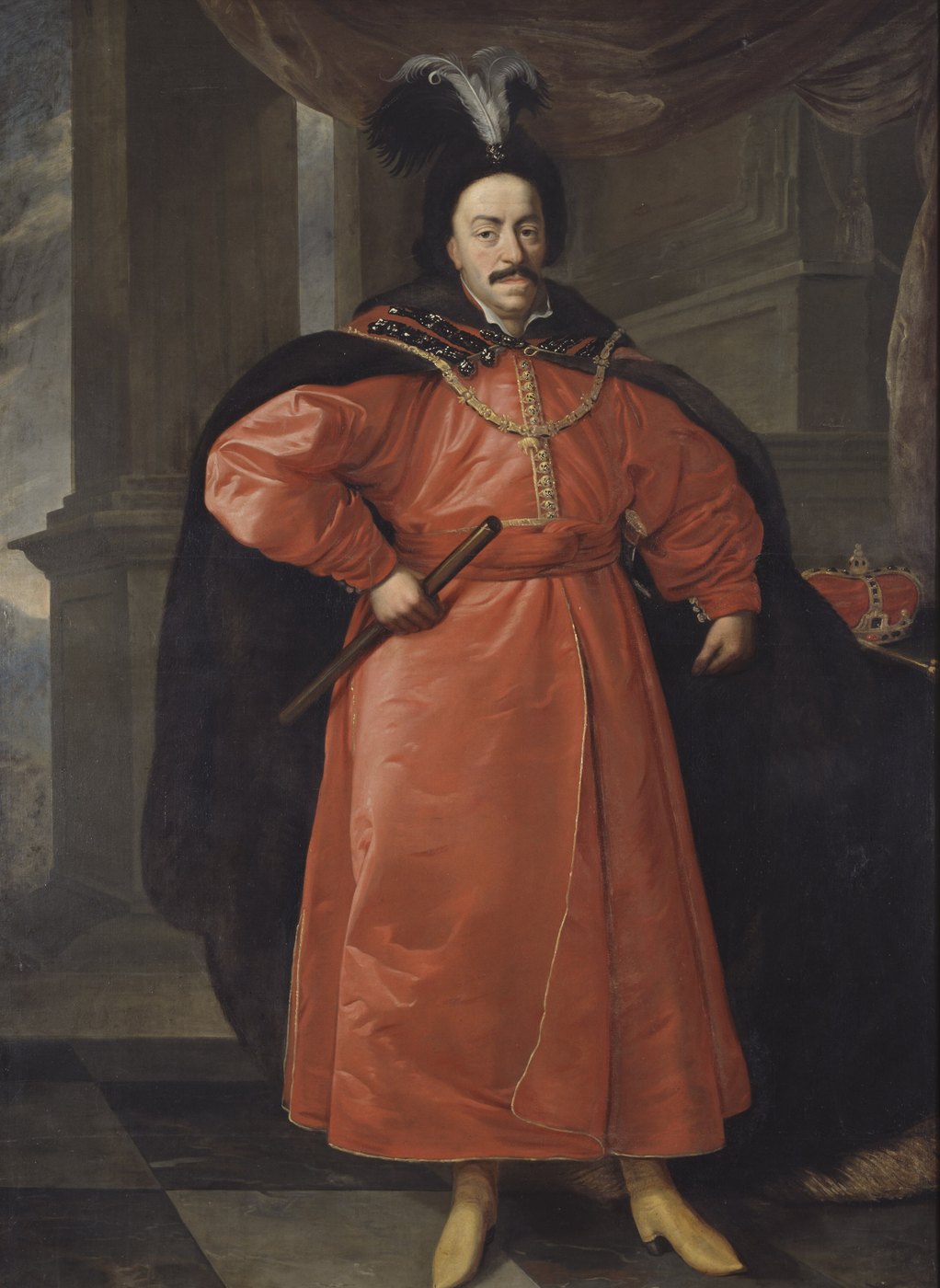 Full-length painted portrait of a mustached man in a long red Polish robe with a fur-lined cloak and a black plumed hat, holding a baton, with a crown on a table beside him