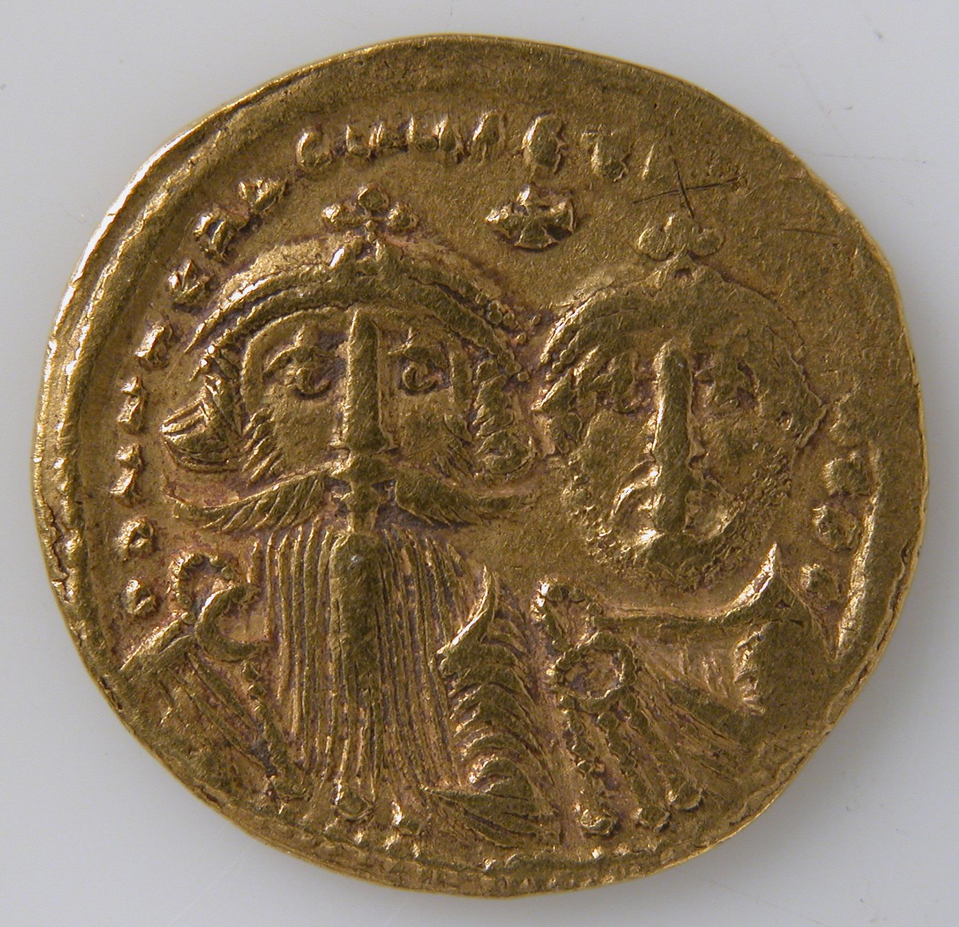 Gold coin showing two crowned busts side by side