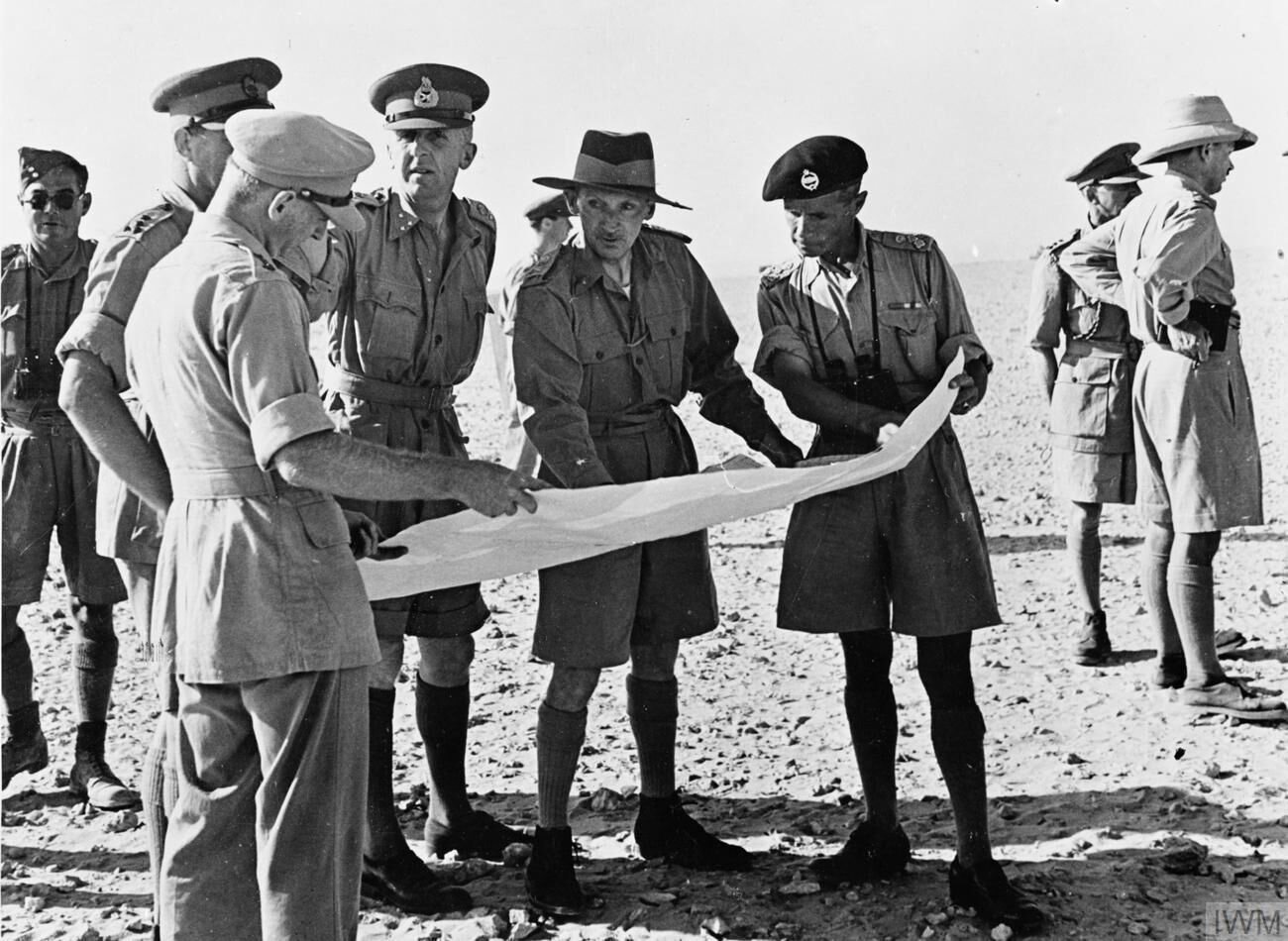 British officers in the desert discussing troop positions