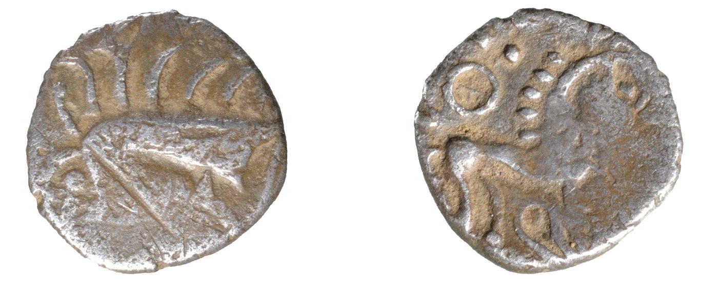 Both faces of a small worn silver coin, a stylized boar on the left and a prancing horse on the right