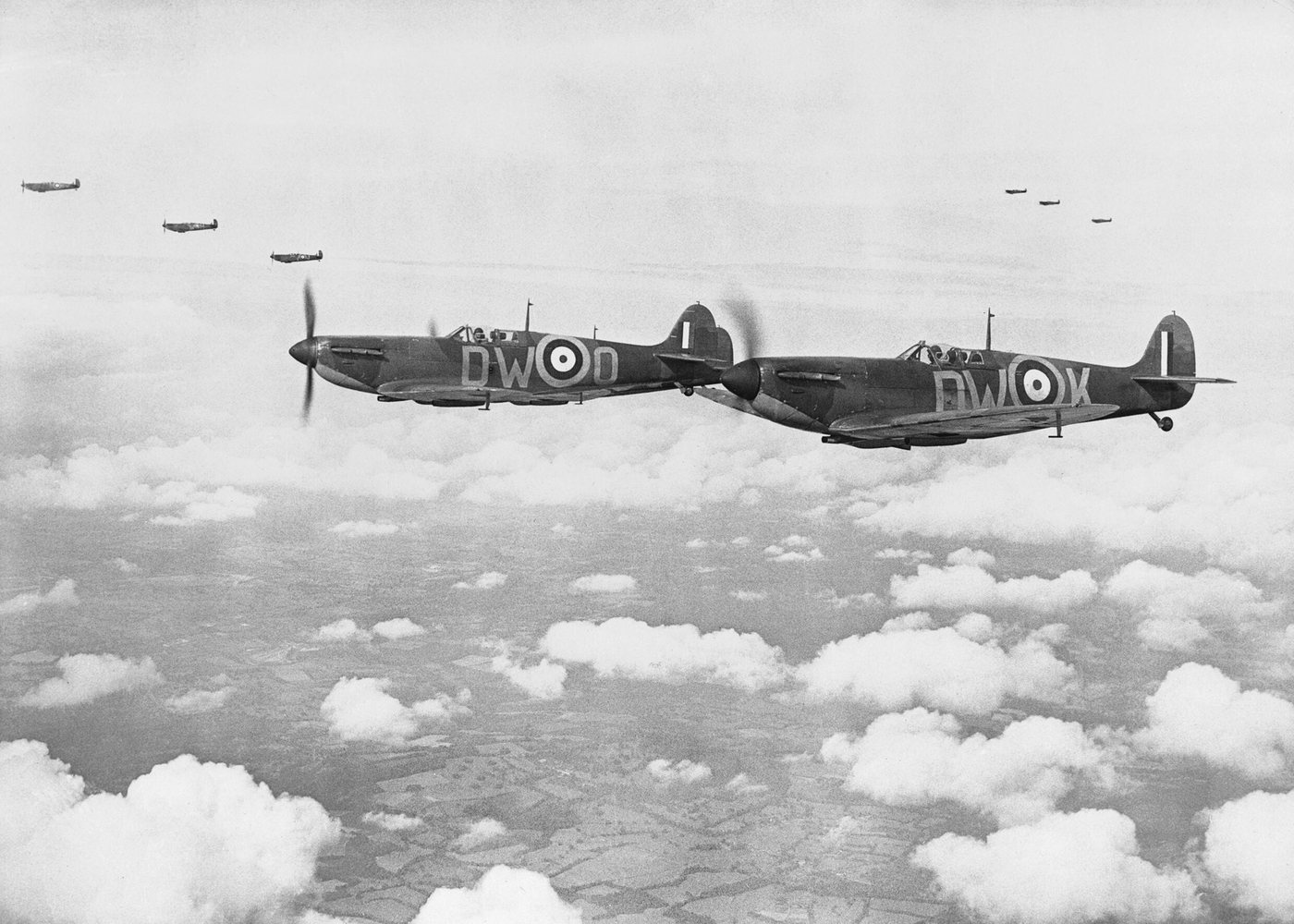 Black and white photograph of Spitfire fighters flying in formation