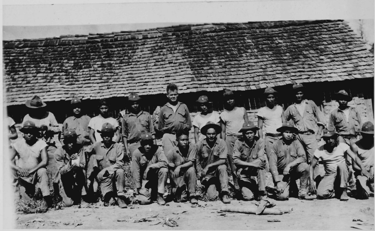 Black and white group photograph of Puller with a row of Nicaraguan soldiers in front of a tiled building