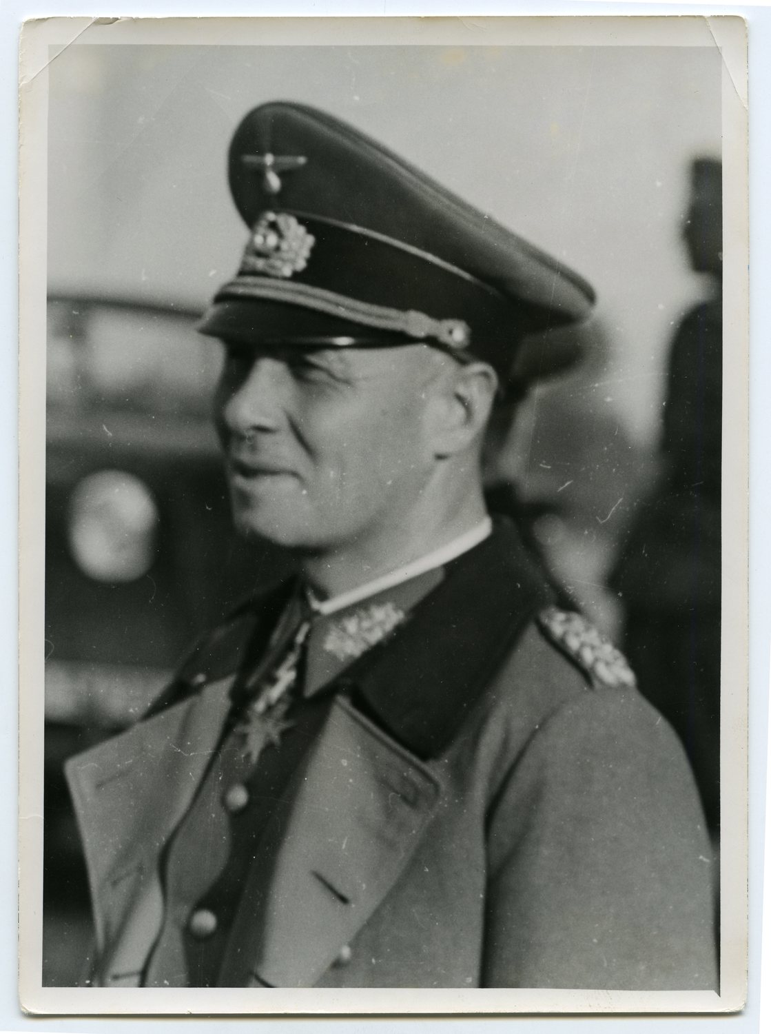 Black and white profile portrait of a German officer in a peaked cap and greatcoat with medals at the collar