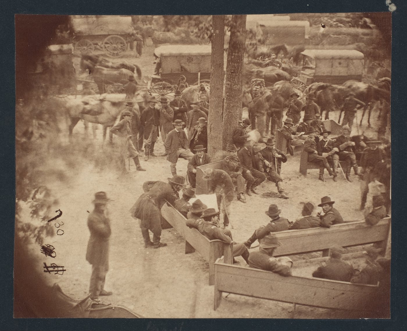 Union officers sitting on church pews outdoors, with Grant bending over to look at a map