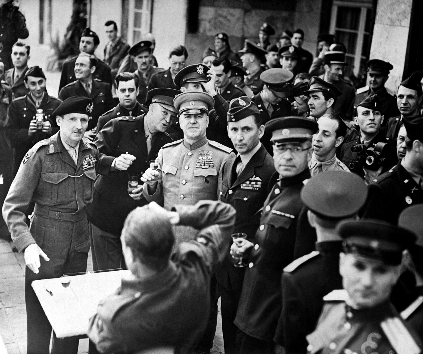Zhukov decorating Montgomery with a medal as officers look on