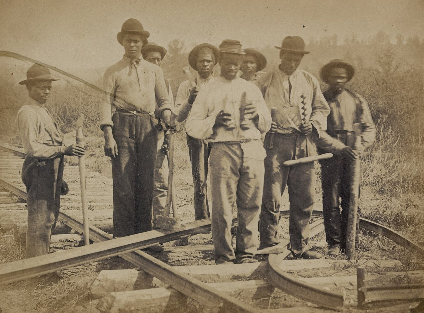 Civil War photograph of men with tools standing on a railroad track