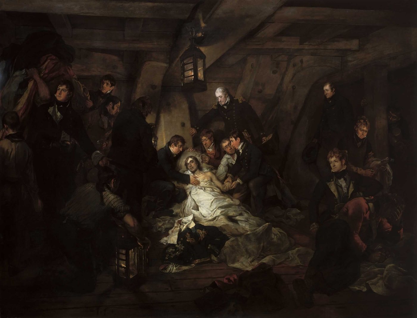 Dark painting of a wounded officer lying below decks lit by lanterns, sailors gathered around
