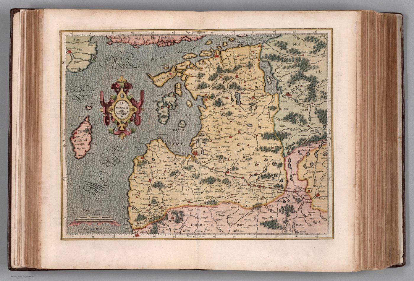 Hand-coloured early modern map of Livonia and the Gulf of Riga in an open atlas