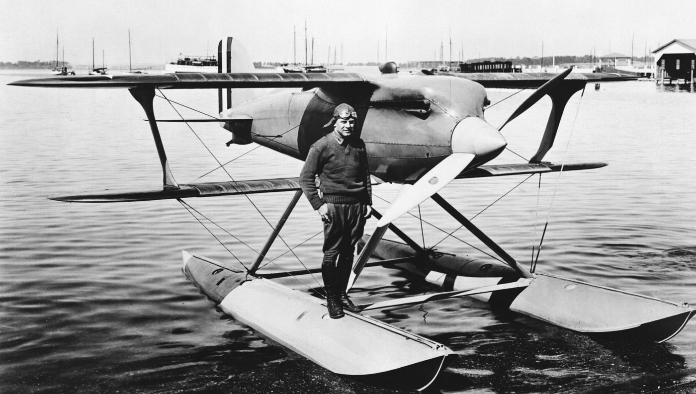 Black and white photograph of Doolittle standing on the float of his Curtiss racing seaplane