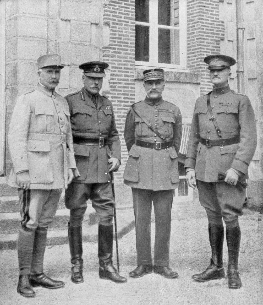 Black and white photograph of four generals in uniform standing in front of a building