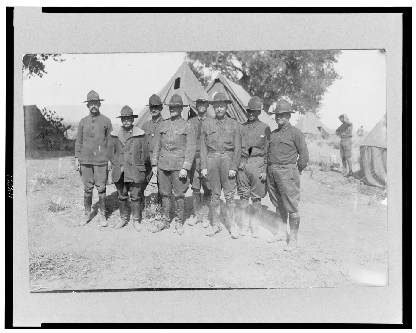 Black and white group photograph of US Army officers outside a tent in the desert