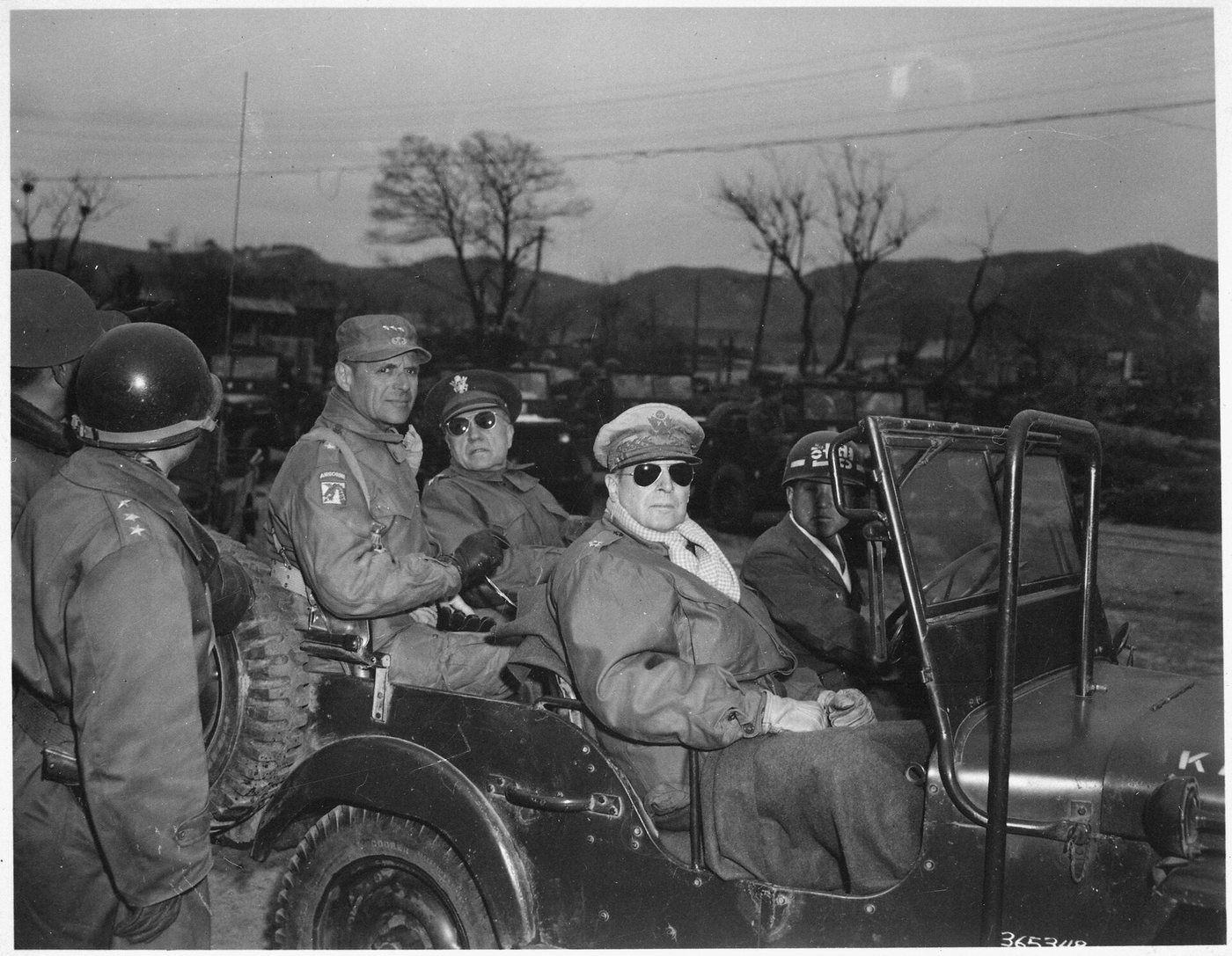 Ridgway, Hickey and MacArthur seated in a jeep in Korea, 1951