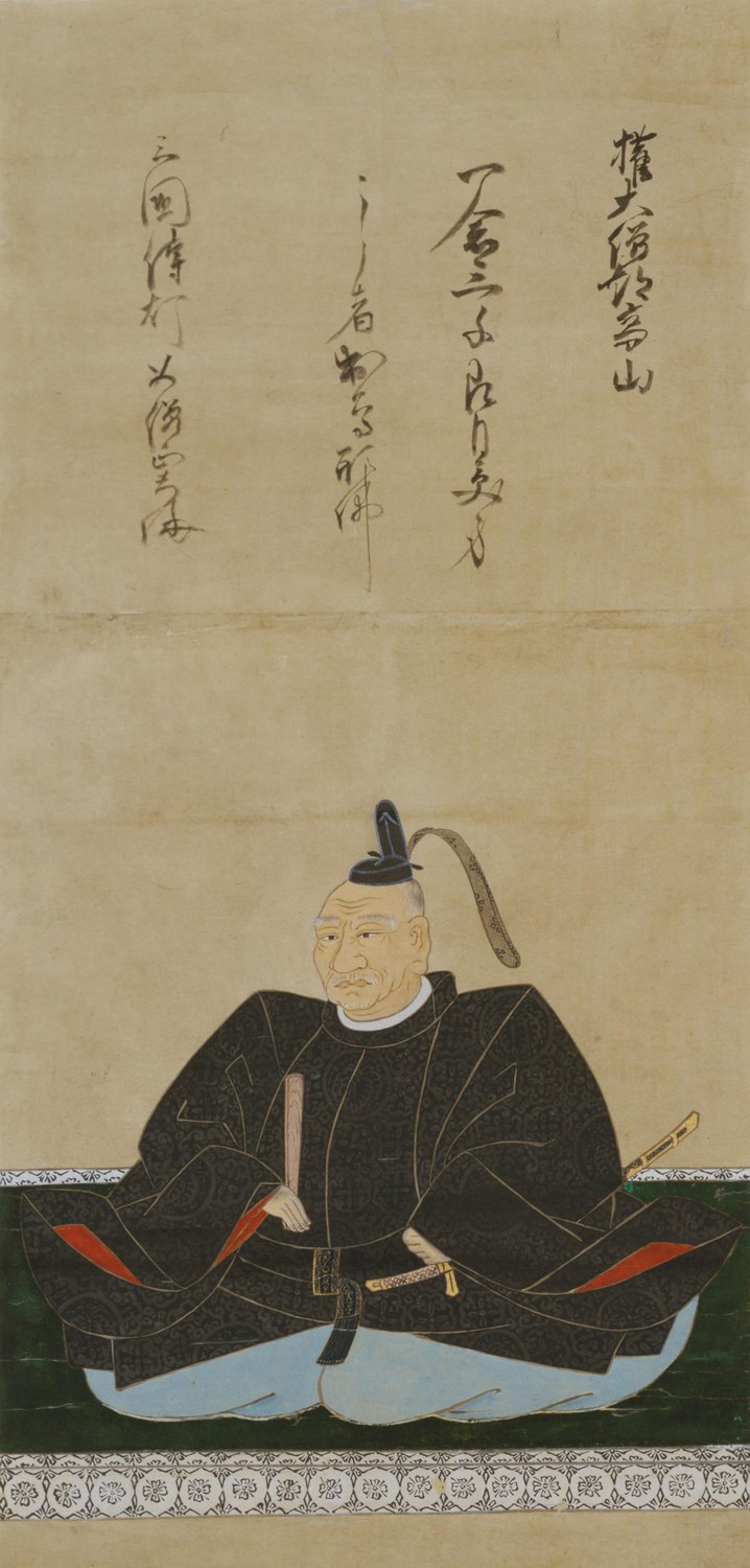 Hanging scroll portrait of an elderly Japanese lord with a white mustache, seated cross-legged in a black patterned robe and pale blue trousers, a tall black court cap on his head, a fan and a short sword at his waist, with four columns of calligraphy above