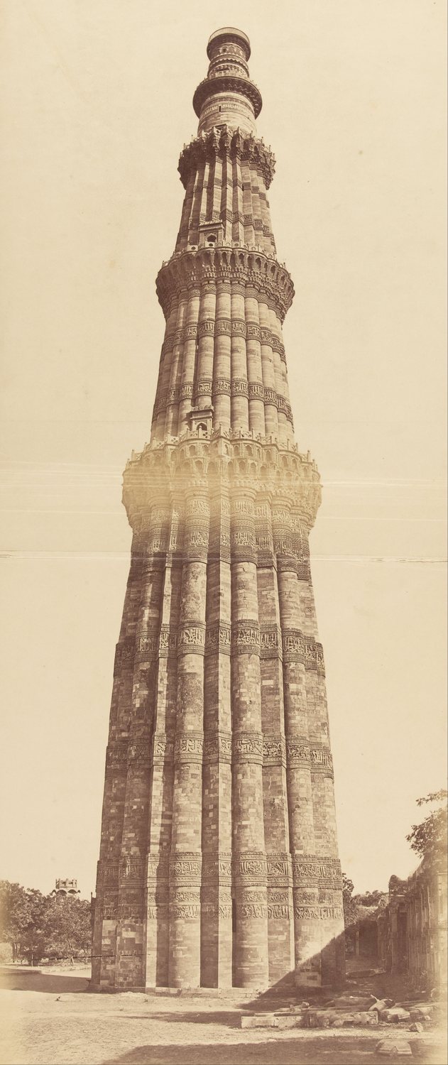 Old photograph of a tall fluted stone tower with balconies