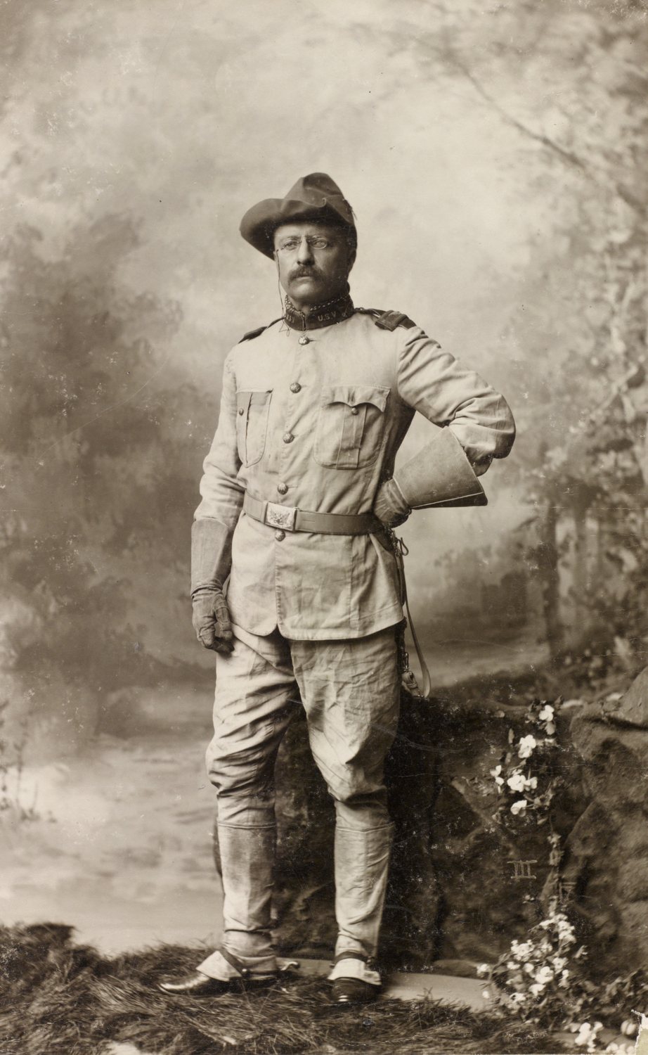 Full length photograph of Roosevelt standing in a cavalry uniform and slouch hat