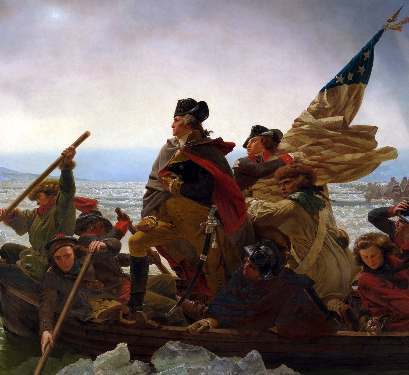Detail of a painting showing George Washington standing in a boat in a cloak, an officer behind him holding a striped flag with stars, and rowers around them amid ice